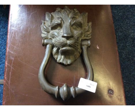 A bronze lion head door knocker.