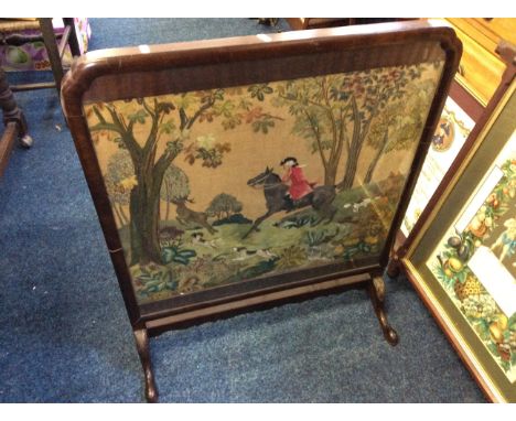 A mahogany framed fire screen with a tapestry hunting scene.