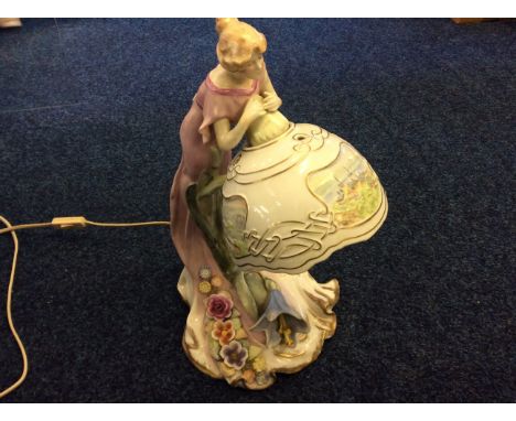 An art nouveau style German lamp with female figurine.