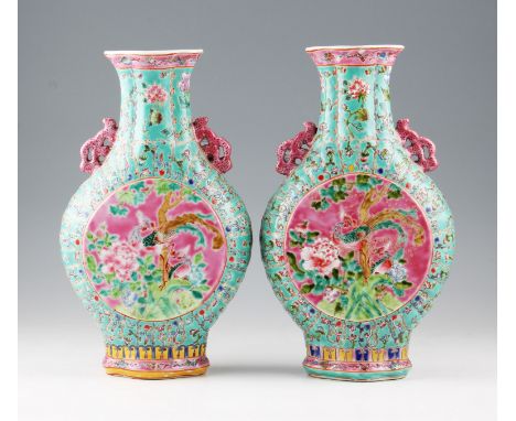 A pair of 20th Century Chinese family rose enamel moon flasks with bird and foliage design centres with other floral decorati