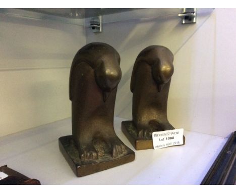 Two bronze penguin figures.
