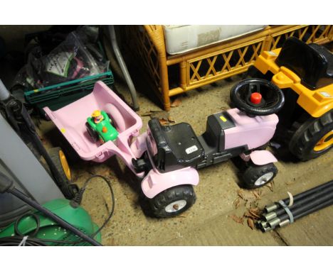 A small pink child's tractor and trailer together with a small toy tractor