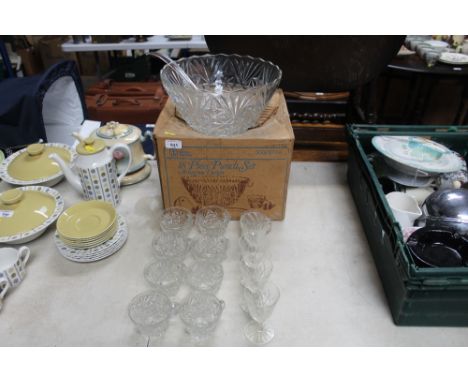 A glass punch bowl and glasses; a plastic ladle and other glassware