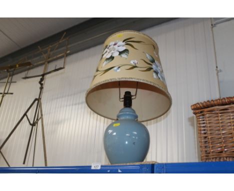 A blue table lamp and shade