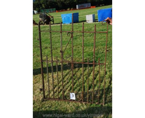 A wrought iron gate, 3' 6" x 4' high with scroll decoration.