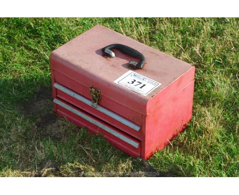 A small red tool box with two drawers. 