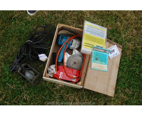 A lead-lamp, a box containing Black and Decker drill circular saw attachment. 