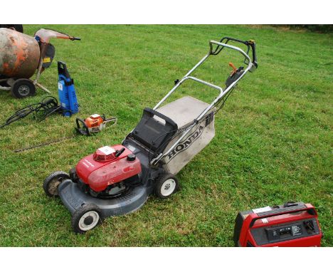 A Honda HR2610 Mower and grass bag. (Engine turns, reluctant to start, good compression.)