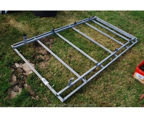 A large galvanised roof rack, possibly for Land-Rover/van, with ladder roller to one end.