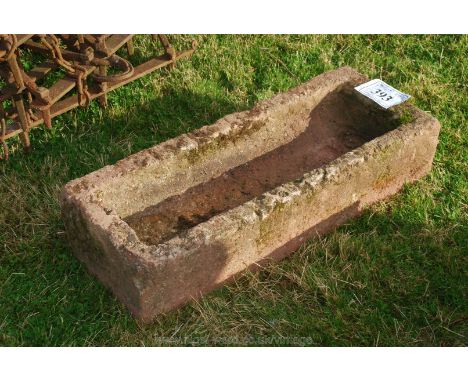 A concrete pig trough 2' 6" long. 