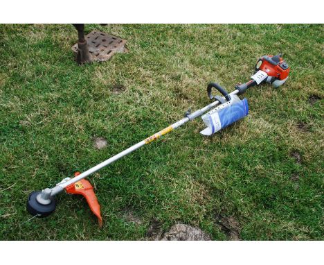 A Husqvarna 325LD self-feed strimmer with instruction manual, (Very little used).