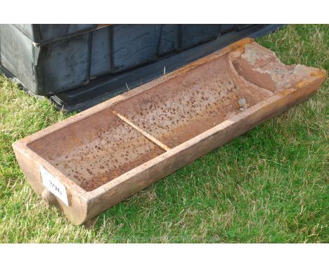 A cast iron pig trough, (Repaired to one end with concrete).