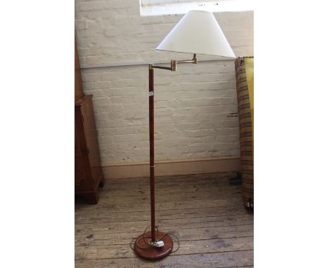 A brass and faux wood metal stem standard lamp
