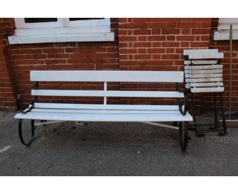 A black iron framed and white wood painted garden bench and two metal and wood slatted folding garden chairs