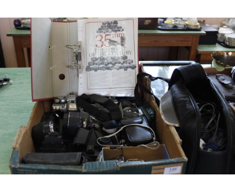 A tray of modern 35mm SLR cameras, lenses plus a video camera