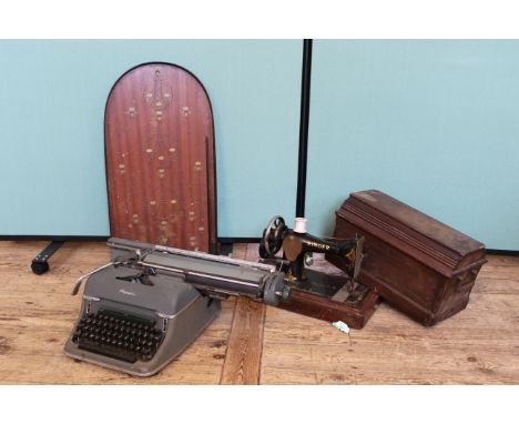 A bagatelle board, singer sewing machine and an Olympia typewriter