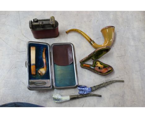 A leather cased cheroot holder, a jumbo lighter plus three assorted pipes