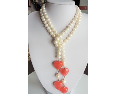 44 inch Peach Jade Cultured Pearl Necklace. A gorgeous cultured pearl necklace with peach jade hearts. The necklace is 44 inc