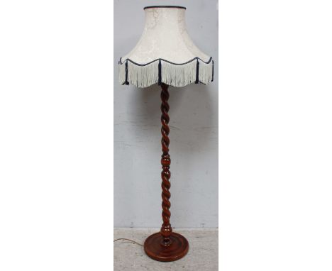 A modern barley twist standard lamp with shade.