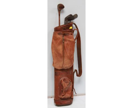 A vintage Fortnum & Mason leather golf bag with five hickory shafted golf clubs including Robert Forgan and J. T. Rush
