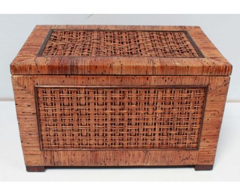 A woven split cane storage trunk with hinged lid and carrying handles, probably Oriental. 79 cm