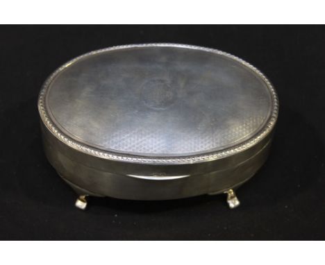 A silver oval jewellery box with engine turned hinged lid and velvet lining. Birmingham 1921