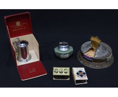 A collection of smoking paraphernalia including a Dunhill novelty 'tankard' lighter in original box, a gilded rotary match di