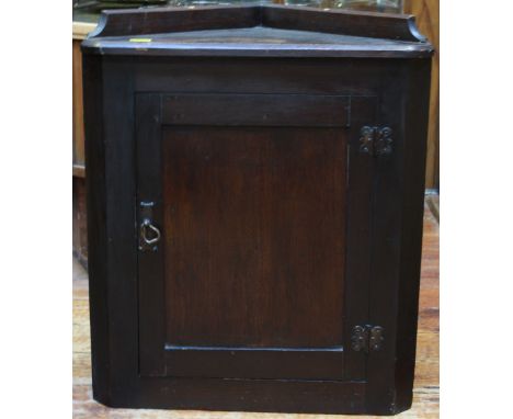 A stained oak hanging corner cupboard, with single panel door enclosing a shelf, 60cm high, together with a 20th Century maho