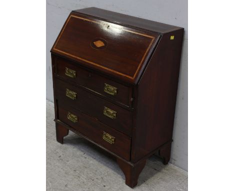 An Edwardian mahogany inlaid bureau, the folding front with inlaid shell and fitted interior, over three long graduated drawe