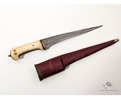 A BONE HILTED INDIAN PESH KABZ DAGGER IN ITS RED LEATHER SCABBARD. The tip of the scabbard has been reinforced with a round s