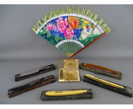 Five cut throat razors, a decorative fan and a yellow metal powder compact and lipstick holder