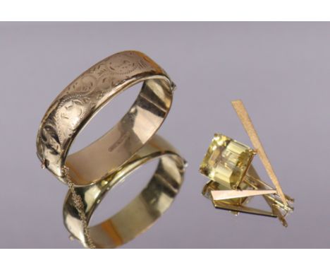 An abstract-form brooch set large square-cut citrine, the yellow metal mount marked “18”; &amp; a 9ct (metal core) stiff hing