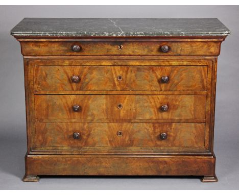 An early 19th  century French figured mahogany commode, with green marble top, fitted one long shallow frieze drawer above th