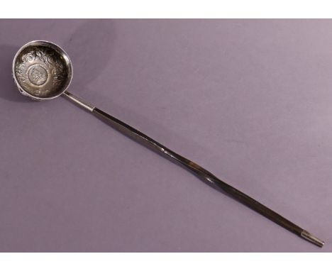 A late 18th century punch ladle, the circular bowl formed from a silver coin, embossed with birds &amp; flowers, inset George