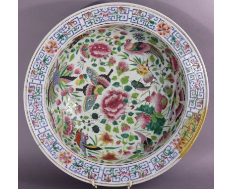 A 19th century Cantonese large porcelain circular basin with famille rose decoration of birds, butterflies &amp; insects in a