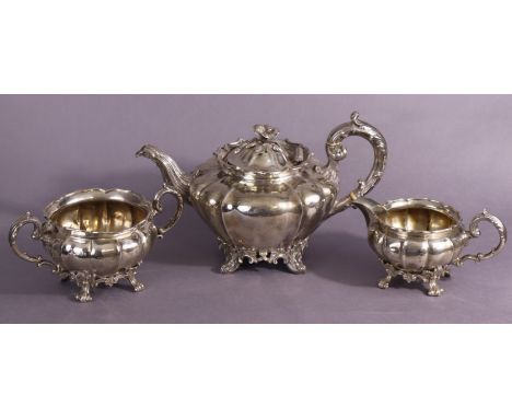 A matched three-piece silver tea service of melon shape, comprising a Victorian teapot with flower-finial, scroll handle and 