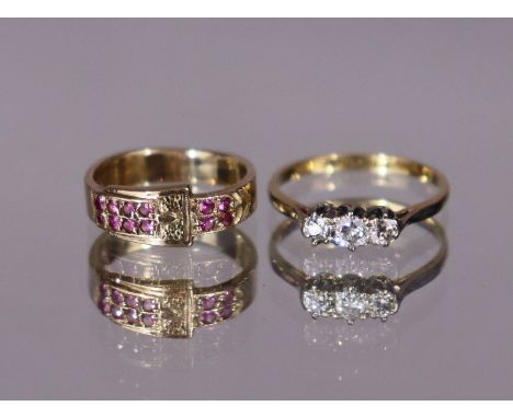 An 18ct gold &amp; platinum ring set three small graduated diamonds, size: J/K (1.6gm); &amp; a yellow metal belt-buckle ring