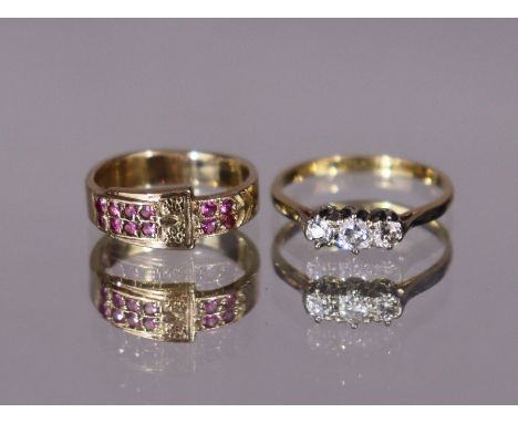 An 18ct gold &amp; platinum ring set three small graduated diamonds, size: J/K (1.6gm); &amp; a yellow metal belt-buckle ring