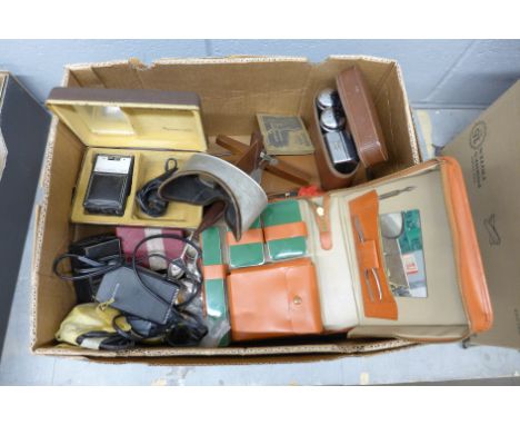 A box of miscellaneous items, Sine compass, travel vanity set, repro US police badges, pocket watch, Marjorie Bates prints, s