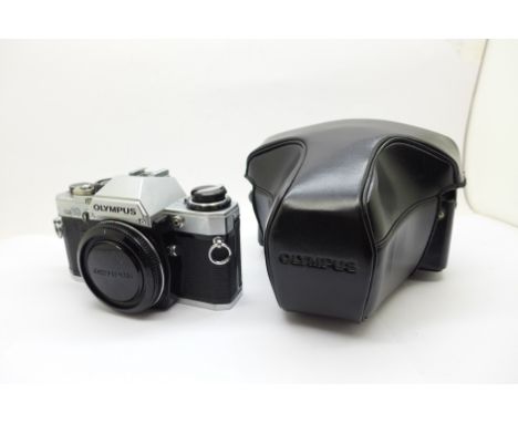 An Olympus OM 10 Body with manual adapter Olympus Body Cap and case 