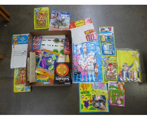 A box containing various vintage childhood toys on display cards 