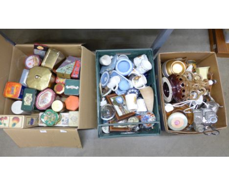 Three boxes of items including a collection of tins, a ceramic lamp base, mugs, china, Wedgwood Jasperware etc.&nbsp;**PLEASE