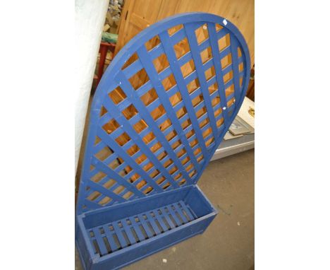 A blue painted wooden planter and arched trellis