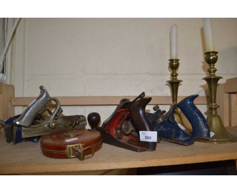 Mixed Lot: Assorted wood working tools, planes, a leather tape measure and a pair of brass candlesticks