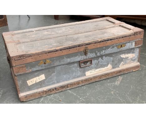 A vintage wooden and metal banded travel trunk, 100cmW, with travel stickers to include Southampton Docks 