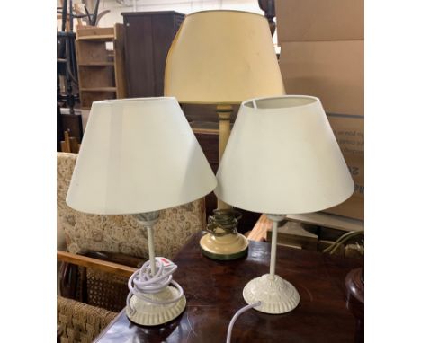 A pair of white painted metal bedside lamps; together with one other painted metal column lamp, 53cmH to top of shade 