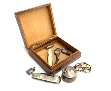 A marquetry box with cherub and chariot inlay design containing a pair of scissors with silver handles (af); small silver tri