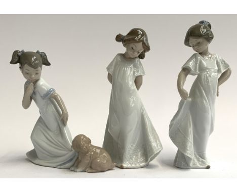 Three Nao by Lladro figurines, two girls in dresses together with a young girl with puppy, the tallest 22cmH 