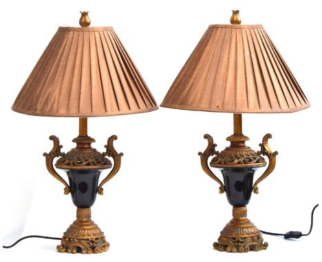 A pair of gilt wood mounted dark glass lamp bases, modern, in the early 19th century French style, brown shades, carved finia