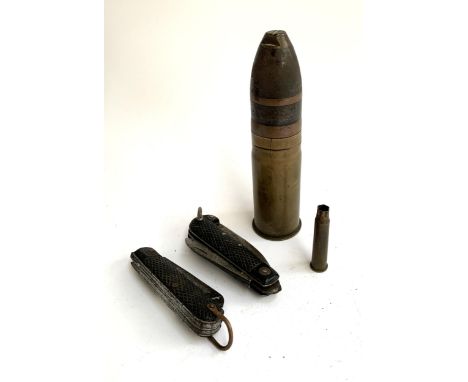 Two army pen knives together with a shell marked VSM 